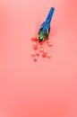 Vertical shot of a handmade bird figure with colorful cotton balls isolated on a red background Royalty Free Stock Photo