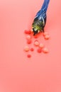 Vertical shot of a handmade bird figure with colorful cotton balls isolated on a red background Royalty Free Stock Photo