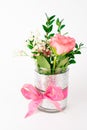 Vertical shot of a small vase with pink bow and roses isolated on a white background Royalty Free Stock Photo