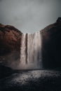 Vertical shot of a small waterfall in the rocks on a gloomy ay in Iceland Royalty Free Stock Photo