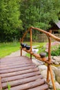 Vertical shot of a small wooden bridge over a pond Royalty Free Stock Photo