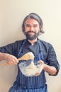 Vertical shot of a smiling bearded male chef mixing dough in a glass bowl Royalty Free Stock Photo