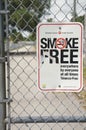Vertical shot of a smoke-free zone sign in a school area Royalty Free Stock Photo