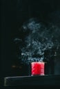 Vertical shot of smoke rising from a cocktail isolated on the black background Royalty Free Stock Photo