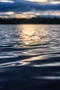 Vertical shot of smooth and calm water ripples with the sunset reflecting on the water Royalty Free Stock Photo