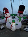 Vertical shot of snowman decorations outdoors during the day for Christmas