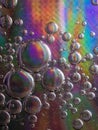 Vertical shot of soap bubbles on a colorful background with interesting textures Royalty Free Stock Photo