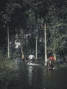 Vertical shot of some people walking in the river in Gonda, India Royalty Free Stock Photo