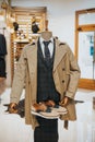 Vertical shot of a sophisticated suit with a pair of derby shoes on the mannequin on the display Royalty Free Stock Photo