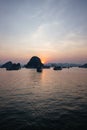 Vertical shot of The South China Sea and boats during sunset in Halong Bay, Vietnam Royalty Free Stock Photo