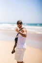 Vertical shot of the Spanish, young man with tattoos at the beach Royalty Free Stock Photo