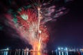 Vertical shot of a Spectacular night sky with an array of fireworks exploding over a body of water Royalty Free Stock Photo