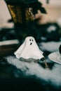 Vertical shot of spooky Halloween decorations, a cupcake decorated like a ghost Royalty Free Stock Photo