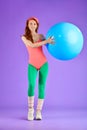 Vertical shot of sporty cute ginger girl training pectorals