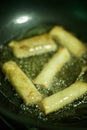 Vertical shot of spring rolls frying in a pan Royalty Free Stock Photo