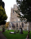 Vertical shot of St James Church with old tombstones in Hemingford Grey Cambridgeshire, England. Royalty Free Stock Photo