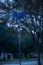 Vertical shot of the 1st street sign by a tree in Pflugerville, Texas