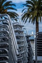 Vertical shot of a stack of chairs with palm trees in the background
