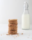 Vertical shot of a stack of chocolate chip cookies and a bottle of milk in the background Royalty Free Stock Photo