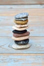 Vertical shot of a stack of flat stones on a wooden table Royalty Free Stock Photo