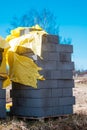 Vertical shot of a stack of gray bricks near a construction site