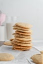 Vertical shot of a stack of homemade cookies with white napkins on a tray