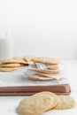 Vertical shot of a stack of homemade cookies with white napkins on a tray