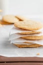 Vertical shot of a stack of homemade cookies with white napkins on a tray