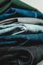 Vertical shot of a stack of neatly folded jeans