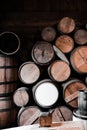 Vertical shot of stack of old wine barrels in the wooden basement Royalty Free Stock Photo