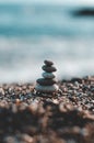 Vertical shot of a stack of pebbles on the beach