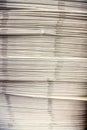 Vertical shot of stacked newspapers on the table