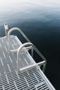 Vertical shot of stairs of a dock leading to the water