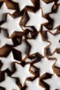 Vertical shot of star-shaped German cinnamon cookies called Zimtstern