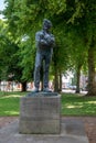 Vertical shot of the statue of the famous WW1 poet Rupert Brooke in a park in Rugby, United Kingdom