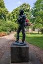 Vertical shot of the statue of the famous WW1 poet Rupert Brooke in a park in Rugby, United Kingdom