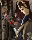 Vertical shot of a statue of a female near a vase of flowers and lamp