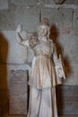Vertical shot of the statue of Greek god Athena in the Bellver Castle in Palma, Spain