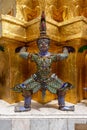 Vertical shot of the statue of a Hindu character Yaksha in The Grand Palace of Bangkok