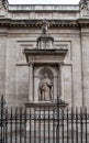 Vertical shot of a statue of John Henry Cardinal Newman outside the Brompton Oratory in London, UK