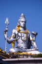 Vertical shot of the Statue of Lord Shiva under the sunlight and a blue sky in Murdeshwar, India Royalty Free Stock Photo