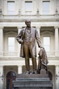 Vertical shot of a statue of a male made by the Michigan Capital building