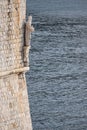 Vertical shot of the statue of Saint Blaise under the turret of city walls of Dubrovnik, Croatia Royalty Free Stock Photo