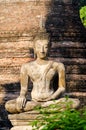 Vertical shot of a statue of sitting Buddha in Wat Chaiwatthanaram temple, Thailand Royalty Free Stock Photo