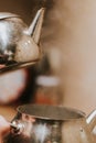 Vertical shot of steaming stainless kettle on the stove