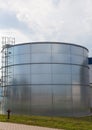 Vertical shot of a steel tank in a field under a gloomy sky