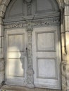 Vertical shot of a stone arched door