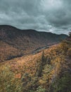 Vertical shot of a stormy sky and autumn scenery of a valley near Quebec City, Canada