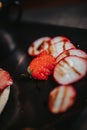 Vertical shot of strawberry garnish on a plate with a blurry background Royalty Free Stock Photo