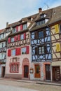 Vertical shot of a street in Colmar, Alsace with typical colorful houses in France Royalty Free Stock Photo